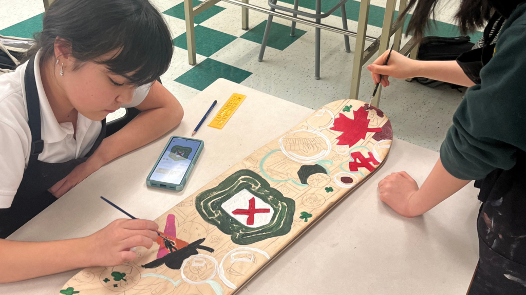 OCSB students painting the skateboard