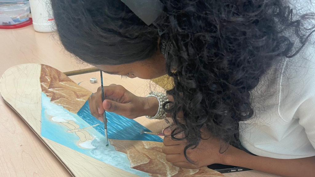 OCSB student painting the skateboard