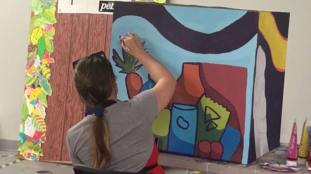 A student from St. Pius X creating artwork honouring women